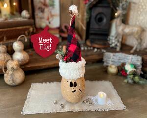 Whimsical Christmas elf decoartion that is made from a real dried gourd. Elf comes with a battery operated candle to light up the face.